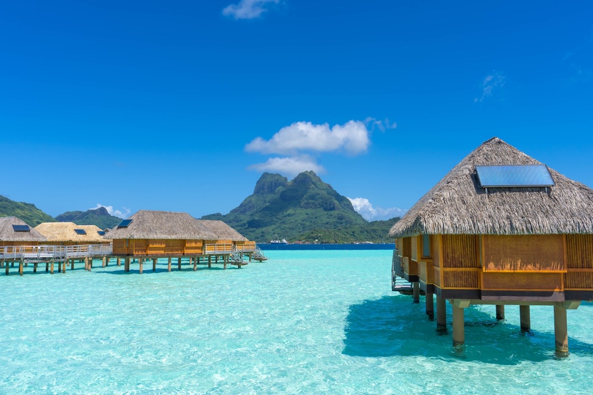Overwater bungalows above a turquoise lagoon
